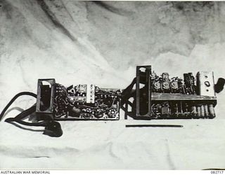 MADANG, NEW GUINEA. 1944-10-12. A NO. 38 SET AND BATTERY USED AS TANK EQUIPMENT DURING TESTS CONDUCTED AT HQ 4 ARMOURED BRIGADE. THE TOP COVER AND SET COVER IS REMOVED, WITH A 6 INCH RULER ..