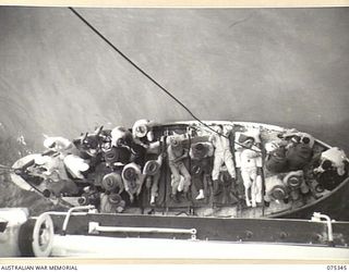 LAE, NEW GUINEA. 1944-08-18. SEAMEN OF THE 2/1ST HOSPITAL SHIP, "MANUNDA" PREPARING TO HOIST A LIFEBOAT LOADED WITH SICK AND WOUNDED ARMY PERSONNEL ABOARD THE VESSEL