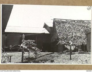 17 MILE, LALOKI RIVER, NEW GUINEA. 1943-11-22. REAR VIEW OF THE CORDIAL FACTORY ESTABLISHED AND OPERATED BY THE AUSTRALIAN DEFENCE CANTEEN SERVICES ATTACHED TO HEADQUARTERS, NEW GUINEA FORCE
