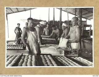 DUMPU, RAMU VALLEY. 1943-11-20. BAKERS OF NO. 2 SECTION, NO. 3 PLATOON, 4TH AUSTRALIAN FIELD BAKERY, PREPARING TO BAKE A BATCH OF BREAD ROLLS FOR THE TROOPS