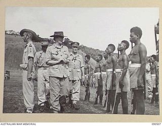 NEAR NADZAB, NEW GUINEA. 1945-03-26. LADY WAKEHURST (3), ACCOMPANIED BY LIEUTENANT GENERAL V.A.H. STURDEE (4), AND MAJOR W.L. DARCEY, BRIGADE MAJOR, PACIFIC ISLANDS REGIMENT (2), INSPECTING C ..