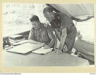 POTSDAM-HANSA BAY, NEW GUINEA. 1944-07-30. NX112702 MAJOR J.P. BUCHANAN, ADMINISTRATIVE COMMANDER, 30TH INFANTRY BATTALION (1) AND NX112707 LIEUTENANT E.G.B. HARRAD, ADJUTANT, 30TH INFANTRY ..