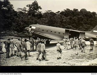 Dreger Harbour, New Guinea. 1943-12-07. A Douglas transport plane is the first large aircraft to land on the new strip built by the 870th United States Aviation Battalion