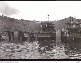 RABAUL, NEW BRITAIN, 1946-01-30. A PREFABRICATED FLOATING DOCK, 400 TONS, WAS ASSEMBLED BY 13 WATER TRANSPORT WORKSHOPS, CORPS OF AUSTRALIAN ELECTRICAL AND MECHANICAL ENGINEERS, AT RABAUL. PARTS ..