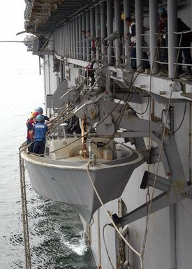 U.S. Navy Sailors aboard a Landing Craft Vehicle personnel boat is lowered over the side of the Tarawa Class Amphibious Assault Ship USS SAIPAN (LHA 2) during operations in the Gulf of Aden on Sept. 6, 2006. SAIPAN is currently underway conducting maritime security operations in the Persian Gulf. (U.S. Navy photo by Mass Communication SPECIALIST SEAMAN McKinley Cartwright) (Released)