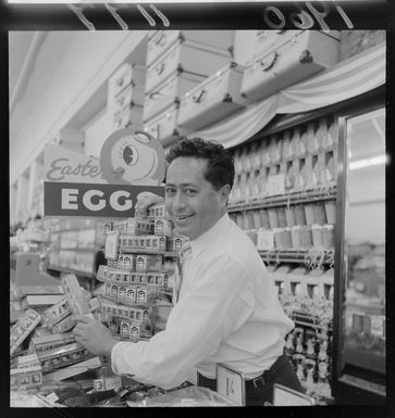 Mr Joe Hunter, of Samoan nationality, stacking Easter eggs in a department store, probably Wellington region