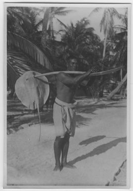 "Bock and Hessle Gilbertöarna Expedition: 1 man dressed hip cladding, with a jaw of lace over his shoulder. Palms in the background. : A series with a photon. 6977: 1-15. "