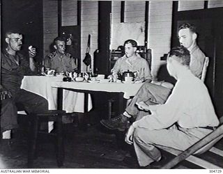 NEW GUINEA. A GROUP OF COASTWATCHERS TAKING TEA. THEY ARE MEMBERS OF THE NAVAL INTELLIGENCE DIVISION, RAN (RESPONSIBLE FOR THE COASTWATCHERS). (NAVAL HISTORICAL COLLECTION)