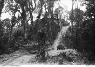 THE SOLOMON ISLANDS, 1945. AUSTRALIAN MANNED JEEP ABOUT TO TACKLE A STEEP CLIMB ON THE NUMA NUMA TRAIL ON BOUGAINVILLE ISLAND. (RNZAF OFFICIAL PHOTOGRAPH.)
