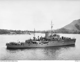 The RAN Corvette, HMAS Rockhampton (J203), at anchor in the bay after her run from Siar with troops of the 25th Infantry Battalion