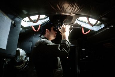 A navigator aboard a KC-135 Stratotanker aircraft operates a sextant during a flight from Guam to Darwin Royal Australian Air Force Base, Australia. The navigator, from the 906th Air Refueling Squadron, 43rd Strategic Wing, Pacific Task Force, is participating in Exercise Glad Customer '82