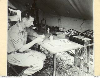 KILIGIA, NEW GUINEA. 1944-03-13. WX3649 SERGEANT M. MCKENNA, DENTAL MECHANIC, MAKING ARTIFICIAL DENTURES AT "E" SECTION, 2/5TH DENTAL UNIT. THE OBJECT OF THE UNIT IS TO PROVIDE DENTAL TREATMENT FOR ..