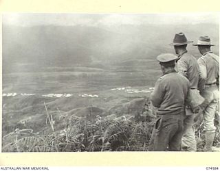 NEW GUINEA. 1944-07-09. MEMBERS OF THE ROYAL AUSTRALIAN ENGINEERS VIEWING THE VERY RUGGED COUNTRY THROUGH WHICH THEY ARE TO BUILD THE NEW WAU-BULLDOG ROAD