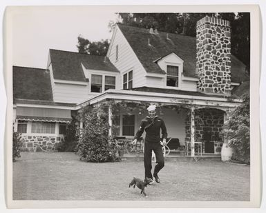 Photograph of Cesar Romero with his dog, Squeaky