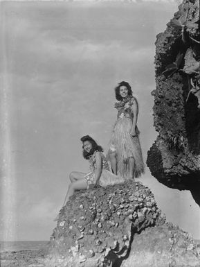 [Portrait of two young Polynesian girls on a coastal rock]