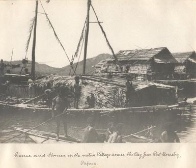 Canoe and houses in the native village across the bay from Port Moresby, Papua New Guinea.