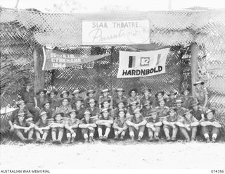 SIAR, NEW GUINEA. 1944-06-25. MEMBERS OF THE 57/60TH INFANTRY BATTALION WINNING SPORTS TEAM WITH THEIR PENNANTS ON THE STAGE OF THE UNIT THEATRE. IDENTIFIED ARE:- VX137507 CORPORAL LEISHMAN (1); ..