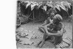 Pig festival, pig sacrifice, Tsembaga: men seated beside a portion of pork, part of an exchange