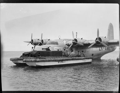 Tasman Empire Airways flying boat, RMA New Zealand ZK-AME, Flying to Fiji, includes unidentified group of men on vessel preparing for depature