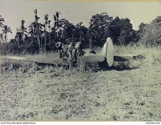 NEW GUINEA, C.1942-12. WIRRAWAY AIRCRAFT USED AS 'CHRISTMAS TREE' TO PROVIDE PARTS FOR OTHER DAMAGED AIRCRAFT. NO.4 SQUADRON RAAF. PERSONNEL ARE LEFT TO RIGHT: CORPORAL SID McGIBBON FITTER IIE, ..