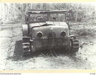 MADANG - ALEXISHAFEN ROAD, NEW GUINEA. 1944-05-26. THE FRONT VIEW OF A JAPANESE ARMOURED TRACTOR POWERED BY A DIESEL ENGINE OF GERMAN DESIGN WHICH WAS ABANDONED ON THE ROAD NEAR MILILAT PLANTATION. ..