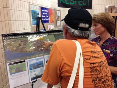 DR-4201-HI. Kilauea Volcano eruption Pupu &lsquoō lava flow in Pahoa, Hawaii. Photo taken during a community briefing helped on November 13, 2014, at the Pahoa High and Intermediate School Cafeteria. Volcanoes National Park Environmental Protection Specialist Danielle Foster listens to concerned Pahoa resident as he points to Ground zero of the ongoing Puʻu ʻŌʻō eruption of Kīlauea Volcano. Foster was one of several federal and local agencies on hand at the Nov. 13 community meeting helped at Pahoa High School on Nov. 13. The weekly meetings serve as a focal point for residents with many questions, comments and concerns over the impending lava flow.