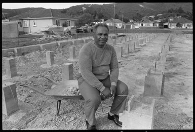 Rev Luteru Vaifale seated among the foundations for the Congregational Christian Church of Samoa, Wainuiomata road