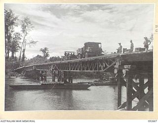 BOUGAINVILLE. 1945-05-30. A NEWLY CONSTRUCTED SAVIGE COMMERCIAL BOX GIRDER BRIDGE OVER THE JABA RIVER WHICH WAS ASSEMBLED BY 11 FIELD COMPANY ROYAL AUSTRALIAN ENGINEERS, TO REPLACE A BRIDGE WASHED ..