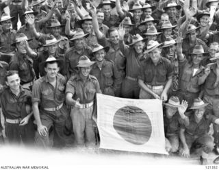 SYDNEY HARBOUR, NSW 1945-12-05. A JAPANESE FLAG CAPTURED AT TAZAKI BY "C" COMPANY OF THE 2/4TH BATTALION AND CONVERTED INTO THE COMPANY'S HONOUR ROLL BY THE OWNER, NX42715 PRIVATE S. DAVIS. PRIVATE ..