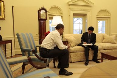Barack Obama makes a phone call in the Oval Office