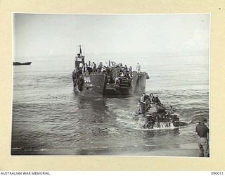 TOKO, BOUGAINVILLE. 1945-03-28. MEMBERS OF B SQUADRON, 2/4 ARMOURED REGIMENT RIDING ASHORE ON A MATILDA TANK, DURING THEIR LANDING FROM AN AMERICAN OPERATED LANDING CRAFT TANK IN THE TOKO COMMAND ..