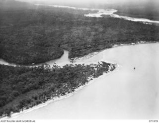 LAE, NEW GUINEA. 1944-03-30. AN AERIAL VIEW SHOWING LABU LAGOON IN THE FOREGROUND AND THE MARKHAM RIVER NEARING ENTRANCE TO THE COAST AT THE REAR
