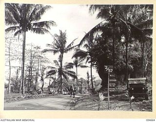TOL AREA, NEW BRITAIN. 1945-08-02. THE ENTRANCE TO 2 FIELD AMBULANCE, WHICH IS OPERATING IN THE TOL AREA. THE HUGE ROCKS IN THE BACKGROUND ARE NEAR THE ROAD