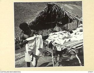 ORO BAY, NEW GUINEA. 1943-07. NATIVES WORKING IN THE LAUNDRY OF THE 10TH FIELD AMBULANCE