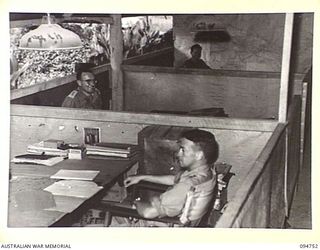 LAE AREA, NEW GUINEA, 1945-08-08. A PORTION OF THE OFFICE ACCOMMODATION USED BY THE ARMY AUDIT STAFF, FIRST AUSTRALIAN ARMY. IDENTIFIED PERSONNEL ARE:- WARRANT OFFICER 1 D. LOCK (1); LIEUTENANT ..