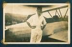 Don Honeysett standing in front of aeroplane, pilot[?] standing on other side of plane, [Bulolo Gold Dredging mine, Bulolo, New Guinea, c1932 to 1933?]