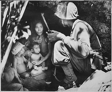 A member of a Marine patrol on Saipan found this family of Japanese hiding in a hillside cave. The mother, four children and a dog, took shelter from the fierce fighting in that area.