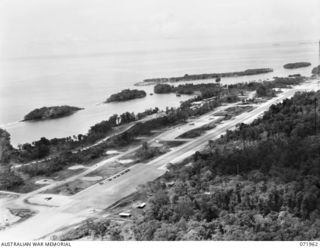 DREGER HARBOUR, NEW GUINEA. 1944-04-03. THE METAL AIRSTRIP IN USE BY COMBAT AND TRANSPORT AIRCRAFT