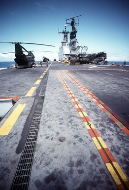 A view of the flight deck aboard the amphibious assault ship USS SAIPAN (LHA-2), looking forward. CH-46 Sea Knight helicopters are lined up on the deck. The SAIPAN is taking part in exercise Ocean Venture '81