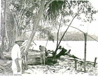 THE SOLOMON ISLANDS, 1945-10-13. BEACH SCENE AT JAPANESE NAVAL INTERNMENT CAMP ON MASAMASA ISLAND. (RNZAF OFFICIAL PHOTOGRAPH.)