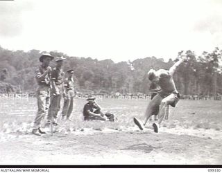 TOROKINA, BOUGAINVILLE, 1945-12-05. SIGNALMAN H. LOGAN, B CORPS SIGNALS, WINNING THE HOP, STEP AND JUMP EVENT WITH A LEAP OF 42 FEET AND 10 INCHES, AT THE 3 DIVISION AMENITIES ATHLETIC CARNIVAL ..