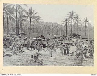 JACQUINOT BAY, NEW BRITAIN. 1945-09-09. TROOPS OF 29/46 INFANTRY BATTALION ARRIVING AT THE WHARF IN TRUCKS TO EMBARK ON HMAS MANOORA. THE MANOORA CARRIED TROOPS FOR THE OCCUPATION OF RABAUL, ..