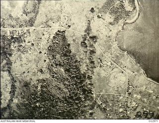 LAE, NEW GUINEA. 1942-08-31. AERIAL PHOTOGRAPH TAKEN DURING A BOMBING ATTACK BY ALLIED FORCES ON A BOMB DUMP