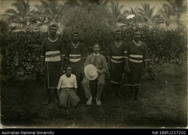 European man with five Papua New Guineans