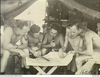 Pouring over a map of Wewak, Beaufort bombing crews of No. 100 (Beaufort) Squadron RAAF yarn over a raid just concluded, while resting in their tents. Left to right: 415620 Flying Officer (FO, ..