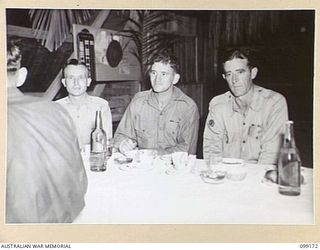 LAE, NEW GUINEA, 1945-12-01. PERSONNEL AT THE OFFICIAL TABLE IN THE SERGEANTS' MESS, 2/1 BASE WORKSHOP, DURING A FORMAL MESS HELD ON THE OCCASION OF THE THIRD ANNIVERSARY OF THE FORMATION OF THE ..