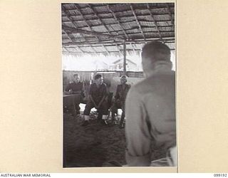 CAPE WOM, NEW GUINEA, 1945-12-01. CORPORAL YAMAMOTO GIVING EVIDENCE TO THE INTERPRETER TO TRANSLATE AT THE TRIAL OF LIEUTENANT TAZAKI, WHO WAS CHARGED WITH AND LATER SENTENCED TO DEATH FOR ..