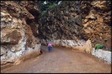 Person walking along road, Mangaia