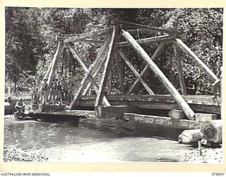 TAUT RIVER, NEW BRITAIN. 1945-02-12. A NEW SINGLE SPAN TRUSS SUSPENSION BRIDGE BUILT OVER A CREEK NEAR THE RIVER BY TROOPS OF THE 13TH FIELD COMPANY