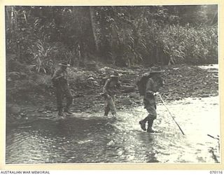 KETOBA, NEW GUINEA. 1944-01-29. MEMBERS OF THE 57/60TH INFANTRY BATTALION CROSSING A STREAM BEFORE MOVING INTO ACTION AGAINST THE JAPANESE